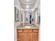 Bathroom vanity with granite countertop and a large mirror reflecting the hallway and bathroom door at 2103 E Canyon Pl, Chandler, AZ 85249