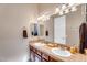 Bathroom with a double vanity, decorative mirrors and tile backsplash at 2103 E Canyon Pl, Chandler, AZ 85249