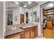 Bathroom vanity with granite countertop, a built-in makeup table, and a view of the walk-in closet at 2103 E Canyon Pl, Chandler, AZ 85249