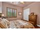 Bedroom with flower-patterned bedding, shuttered window and wooden dresser at 2103 E Canyon Pl, Chandler, AZ 85249