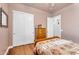 Bedroom with hardwood floors, white closets, a wooden dresser, and a floral-patterned bedspread at 2103 E Canyon Pl, Chandler, AZ 85249