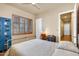 Bedroom with a desk area, a shuttered window and an industrial style bed frame at 2103 E Canyon Pl, Chandler, AZ 85249