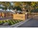 Gated community entrance with a brick sign and lush landscaping for a welcoming feel at 2103 E Canyon Pl, Chandler, AZ 85249