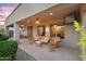 Relaxing covered patio featuring comfortable seating, ceiling fans, recessed lighting, and a mounted TV for outdoor entertainment at 2103 E Canyon Pl, Chandler, AZ 85249