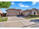 Charming single-story home featuring a three-car garage and well-maintained landscaping at 2103 E Canyon Pl, Chandler, AZ 85249
