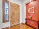 Bright foyer featuring a wood door, stylish console table, and adjacent window with natural light at 2103 E Canyon Pl, Chandler, AZ 85249