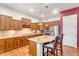 Updated kitchen featuring wood cabinets, stainless steel appliances, and a granite island with bar seating at 2103 E Canyon Pl, Chandler, AZ 85249