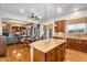 The open kitchen features a granite island, stainless appliances, and hardwood floors, flowing into the dining and living areas at 2103 E Canyon Pl, Chandler, AZ 85249