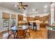 Inviting kitchen with wood cabinets, granite counters, and a center island, adjacent to a cozy dining area at 2103 E Canyon Pl, Chandler, AZ 85249
