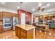 A spacious kitchen boasts stainless steel appliances and a large island with granite countertops and hardwood floors at 2103 E Canyon Pl, Chandler, AZ 85249