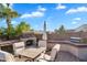 Wonderful outdoor kitchen includes a grill and dining area with a beautiful brick oven, perfect for entertaining guests in the backyard at 2103 E Canyon Pl, Chandler, AZ 85249
