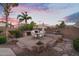 Beautiful outdoor kitchen features a brick oven, bar, grill, and dining area, perfect for entertaining in the Arizona sunset at 2103 E Canyon Pl, Chandler, AZ 85249