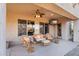 Beautiful covered patio featuring cozy wicker furniture and an outdoor TV for relaxation at 2103 E Canyon Pl, Chandler, AZ 85249