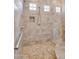 Tiled walk-in shower with a built-in shelf, a shower head, and a grab bar for accessibility at 2103 E Canyon Pl, Chandler, AZ 85249