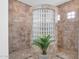Walk-in shower featuring tiled walls, glass block window, tiled floor, and a potted plant at 2103 E Canyon Pl, Chandler, AZ 85249