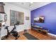 Workout room featuring exercise equipment, hardwood floors and a shuttered window at 2103 E Canyon Pl, Chandler, AZ 85249