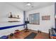 Workout room with exercise equipment, shelving and shuttered window at 2103 E Canyon Pl, Chandler, AZ 85249