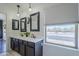 Bright bathroom featuring a double vanity, dark framed mirrors, and modern fixtures at 2135 S Bristol --, Mesa, AZ 85209