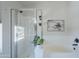 Bathroom featuring a soaking tub and glass-door walk-in shower with modern fixtures at 2135 S Bristol --, Mesa, AZ 85209