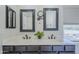 Bright bathroom featuring a double vanity, dark framed mirrors, and modern fixtures at 2135 S Bristol --, Mesa, AZ 85209