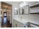 Bathroom with a single vanity, black framed mirror, and view of laundry room at 2135 S Bristol --, Mesa, AZ 85209