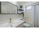 Bright bathroom featuring a single sink vanity, black framed mirror, and a shower and tub combo at 2135 S Bristol --, Mesa, AZ 85209