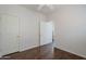 Bright bedroom with hardwood floors and white doors that lead to the hallway at 2135 S Bristol --, Mesa, AZ 85209