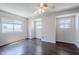 Spacious bedroom with dark laminate flooring and multiple windows providing ample natural light at 2135 S Bristol --, Mesa, AZ 85209