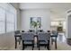 Bright dining room features modern chairs and a stylish table set beneath a window at 2135 S Bristol --, Mesa, AZ 85209