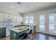 Charming kitchen with green lower cabinets, white upper cabinets, an island, and pool views at 2135 S Bristol --, Mesa, AZ 85209