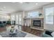 Warm living room features modern fireplace, lots of light, and hardwood flooring for stylish charm at 2135 S Bristol --, Mesa, AZ 85209