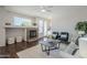 Cozy living room with a stone fireplace, hardwood floors, and ample natural light at 2135 S Bristol --, Mesa, AZ 85209
