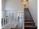 Bright foyer featuring wood staircase with white risers and a view of the dining and living area at 2135 S Bristol --, Mesa, AZ 85209