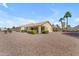 Spacious backyard with desert landscaping, patio, and privacy hedges at 22609 S 214Th Way, Queen Creek, AZ 85142