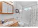Bright bathroom featuring a vanity, toilet, and shower with decorative curtains at 22609 S 214Th Way, Queen Creek, AZ 85142