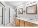 Bright bathroom featuring double sinks, wood cabinets and a glass door shower stall at 22609 S 214Th Way, Queen Creek, AZ 85142