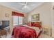 Cozy bedroom featuring a comfortable bed, ceiling fan, and ample natural light at 22609 S 214Th Way, Queen Creek, AZ 85142
