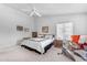 Bright primary bedroom with a ceiling fan and a large bed with a black and white comforter at 22609 S 214Th Way, Queen Creek, AZ 85142