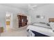 Bright primary bedroom with a ceiling fan, ensuite bathroom and a large bed with a black and white comforter at 22609 S 214Th Way, Queen Creek, AZ 85142