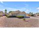 Charming home with a two-car garage, desert rock landscaping, and lush, manicured bushes at 22609 S 214Th Way, Queen Creek, AZ 85142