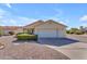 Well-maintained home with a two-car garage and low maintenance landscaping with desert rock and manicured bushes at 22609 S 214Th Way, Queen Creek, AZ 85142