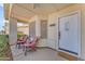 Covered front porch featuring seating, a white door and lots of shade at 22609 S 214Th Way, Queen Creek, AZ 85142