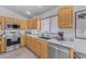 Bright kitchen with stainless steel appliances, light wood cabinets, and marble countertops at 22609 S 214Th Way, Queen Creek, AZ 85142