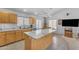 Kitchen with island features stainless steel appliances, lots of light, and tile floors at 22609 S 214Th Way, Queen Creek, AZ 85142