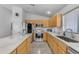 Modern kitchen with stainless steel appliances, light wood cabinets, and a spacious island at 22609 S 214Th Way, Queen Creek, AZ 85142