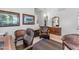 Spacious office featuring a leather chair and desk, decorated with framed artwork, and a decorative mirror at 22609 S 214Th Way, Queen Creek, AZ 85142