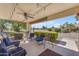 Inviting outdoor patio with comfortable seating, ceiling fan, and views of the green golf course at 22609 S 214Th Way, Queen Creek, AZ 85142