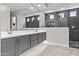Modern bathroom featuring double sinks, stylish mirrors, and walk-in shower at 23097 N 95Th Dr, Peoria, AZ 85383