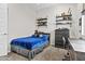 Stylish bedroom with shelves, a comfortable carpet, a modern bed, and a blue comforter, perfect for relaxation at 23097 N 95Th Dr, Peoria, AZ 85383