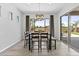 Dining room showcasing a modern chandelier, large windows, sliding glass doors, and a table for six at 23097 N 95Th Dr, Peoria, AZ 85383